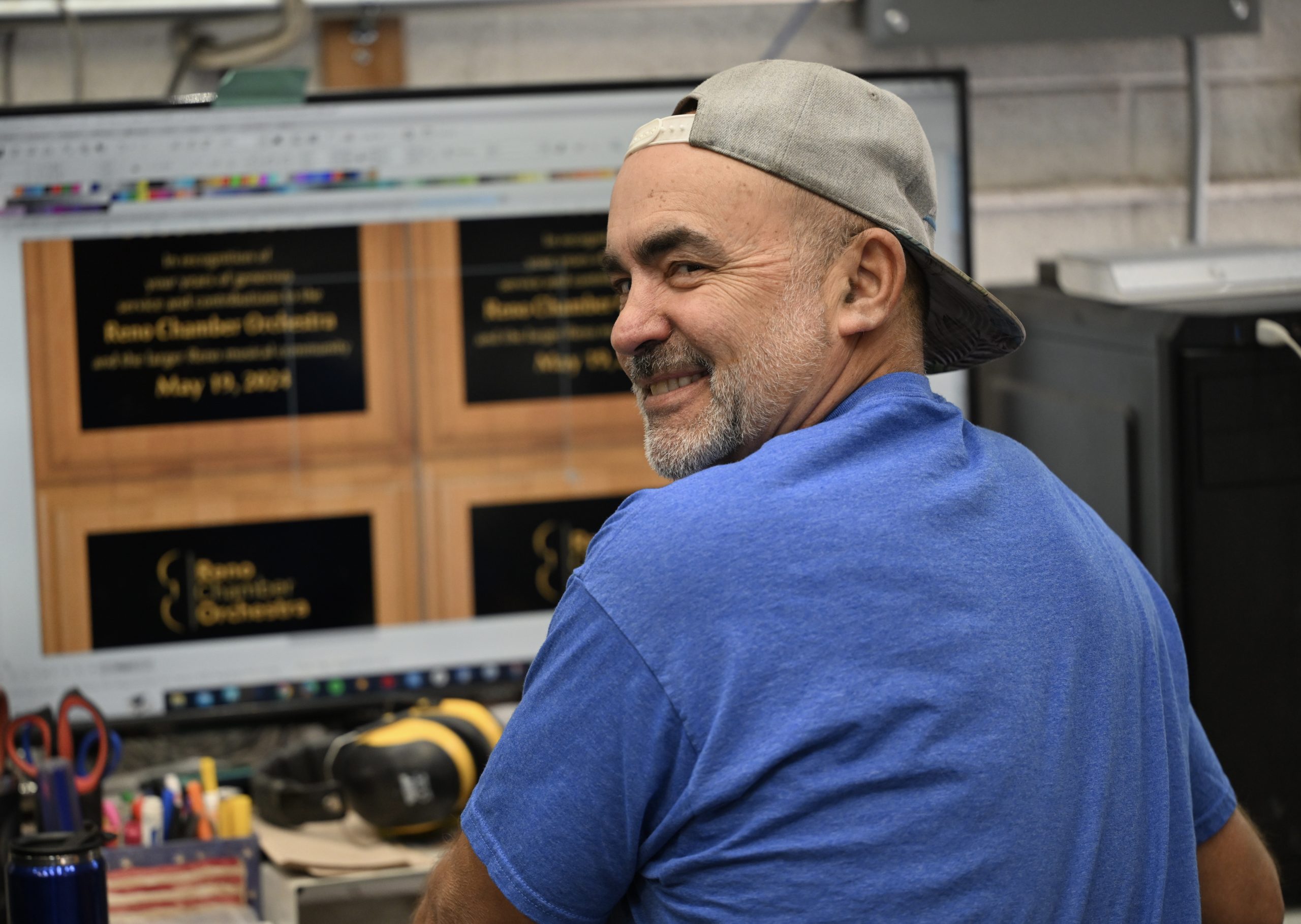 Man smiling while working at a computer.