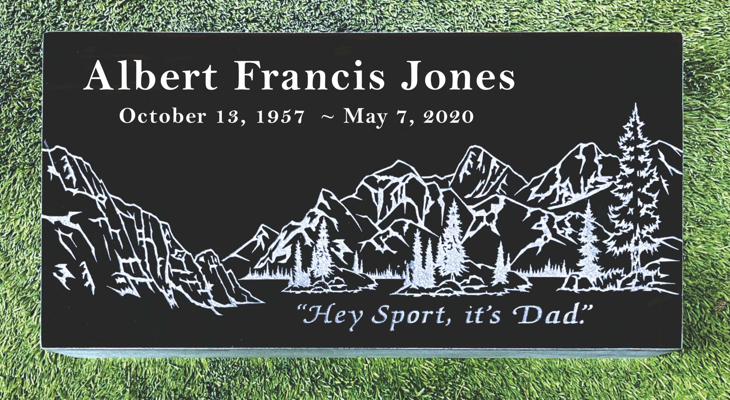 Memorial stone with mountains and trees engraving