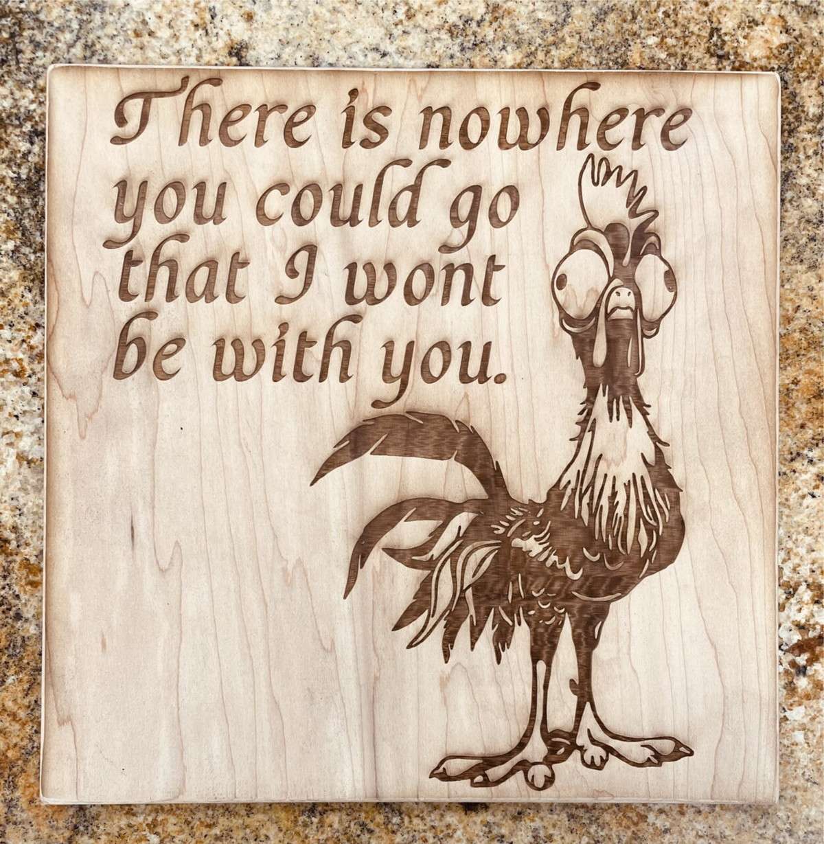 Wooden sign with engraved rooster and quote.