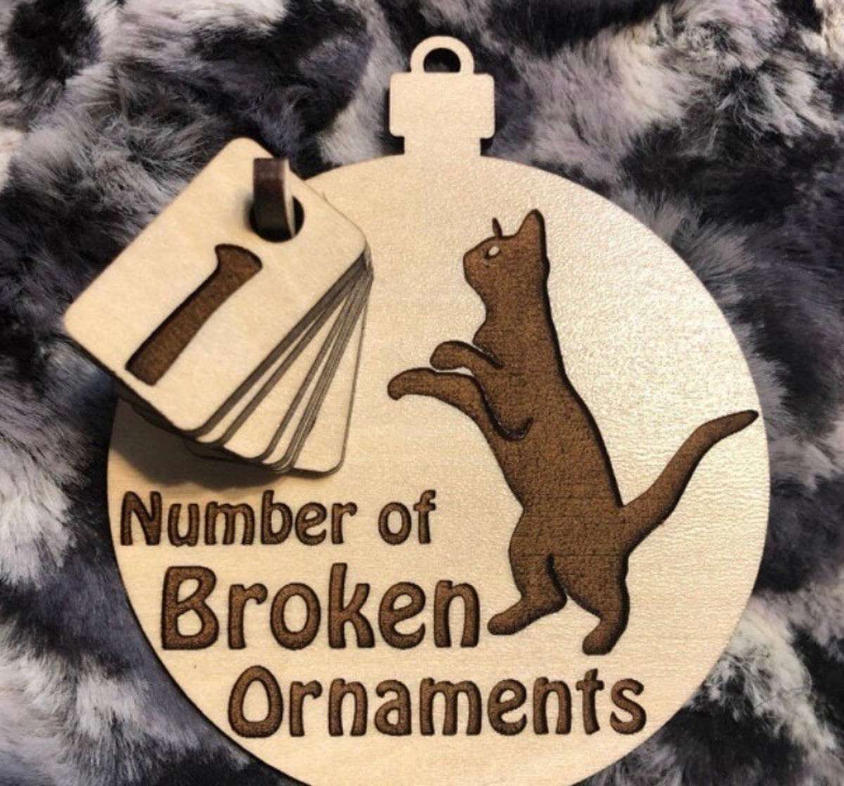Wooden ornament tracker with cat design.
