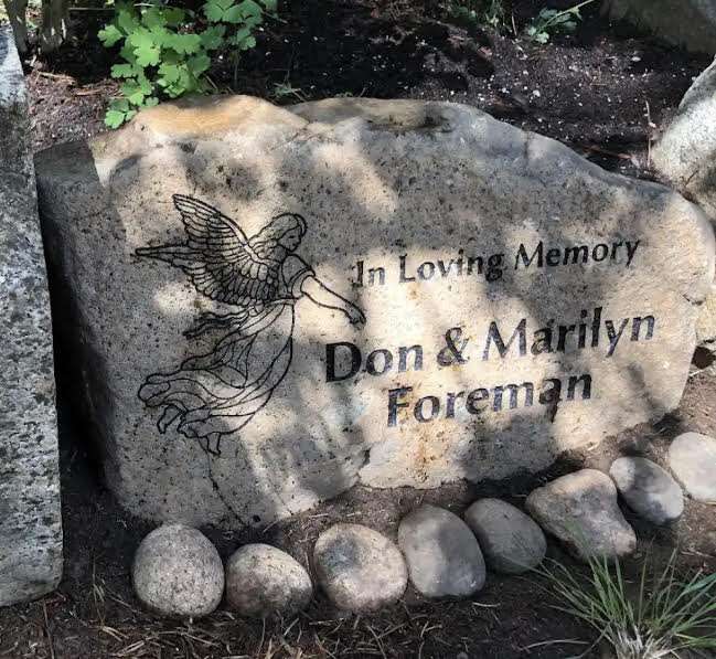 Memorial stone with angel engraving and names.
