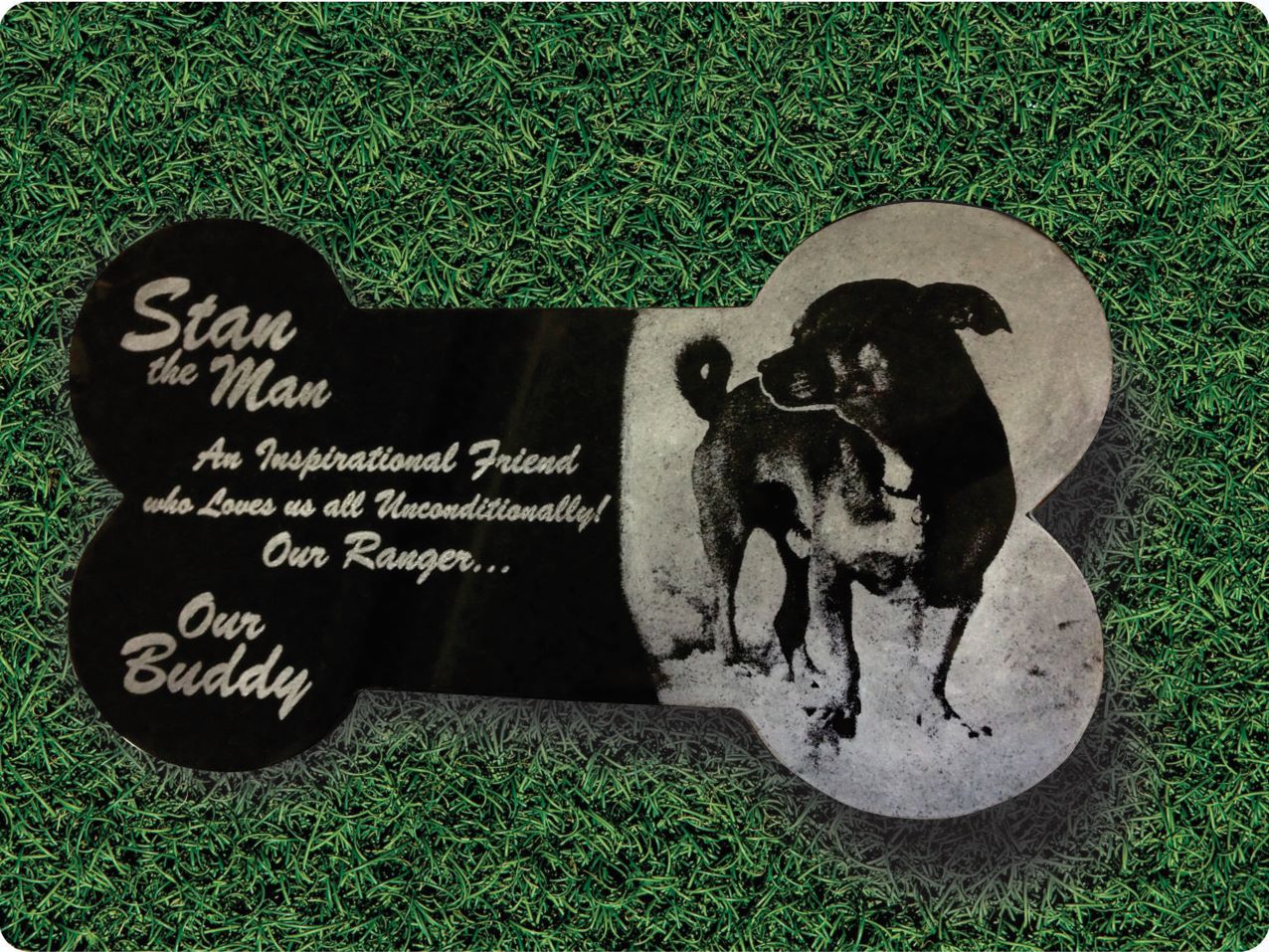Stan the dog's memorial plaque on grass